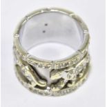 IN THE STYLE OF CARTIER; a yellow and white metal diamond set broad ring decorated with panthers,