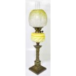A Victorian oil lamp, the yellow and clear glass shade with moulded and etched floral decoration