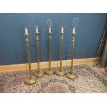 A harlequin set of five gilt standard lamps, with fluted columns on circular plinth bases, height