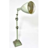 A green painted cast metal anglepoise type industrial work lamp, height 71cm.