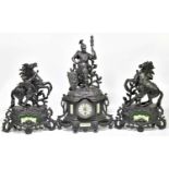 A late 19th century black painted spelter clock garniture, the clock with soldier finial above the