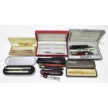 A small collection of pens to include two Cross examples stamped 925, a rolled gold Parker Pen, a