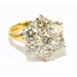 An 18ct yellow gold seven stone diamond flower head ring, the diamonds totalling approx. 4.10cts,