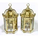 A pair of good quality modern brass wall lights, with loop tops, and glazed fronts, height 51cm.