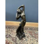 A decorative bronzed figure of a nude female standing with a wave crashing behind her, height