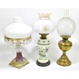 A Victorian painted opaque oil lamp with moulded glass shade, height 53cm, together with a cut glass
