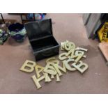 A collection fairground letters in a black tin trunk.