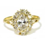 An 18ct yellow gold oval diamond cluster ring, the central oval cut stone weighing 1ct within a