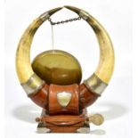 A bull horn dinner gong, on mahogany base, height 42cm.
