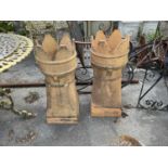 Two castle top chimney pots, height 79cm (2).