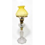 ST LOUIS; a frosted and cut glass oil lamp, the moulded yellow shade of tapering form above a cut