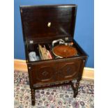 APOLLO; an early 20th century oak cased gramophone cabinet, with panelled front in a Jacobean style,