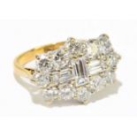 An 18ct yellow gold and diamond cluster ring formed of round brilliant and baguette cut stones,