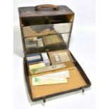 An early 20th century leather surgeon's case, the hinged cover enclosing four metal lined drawers