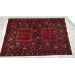 A good quality Bokhara type rug, decorated with stylised motifs on a red groud, approx 266 x 162cm.