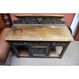 A late 19th century carved oak sideboard in the Flemish taste with raised back carved with the Green