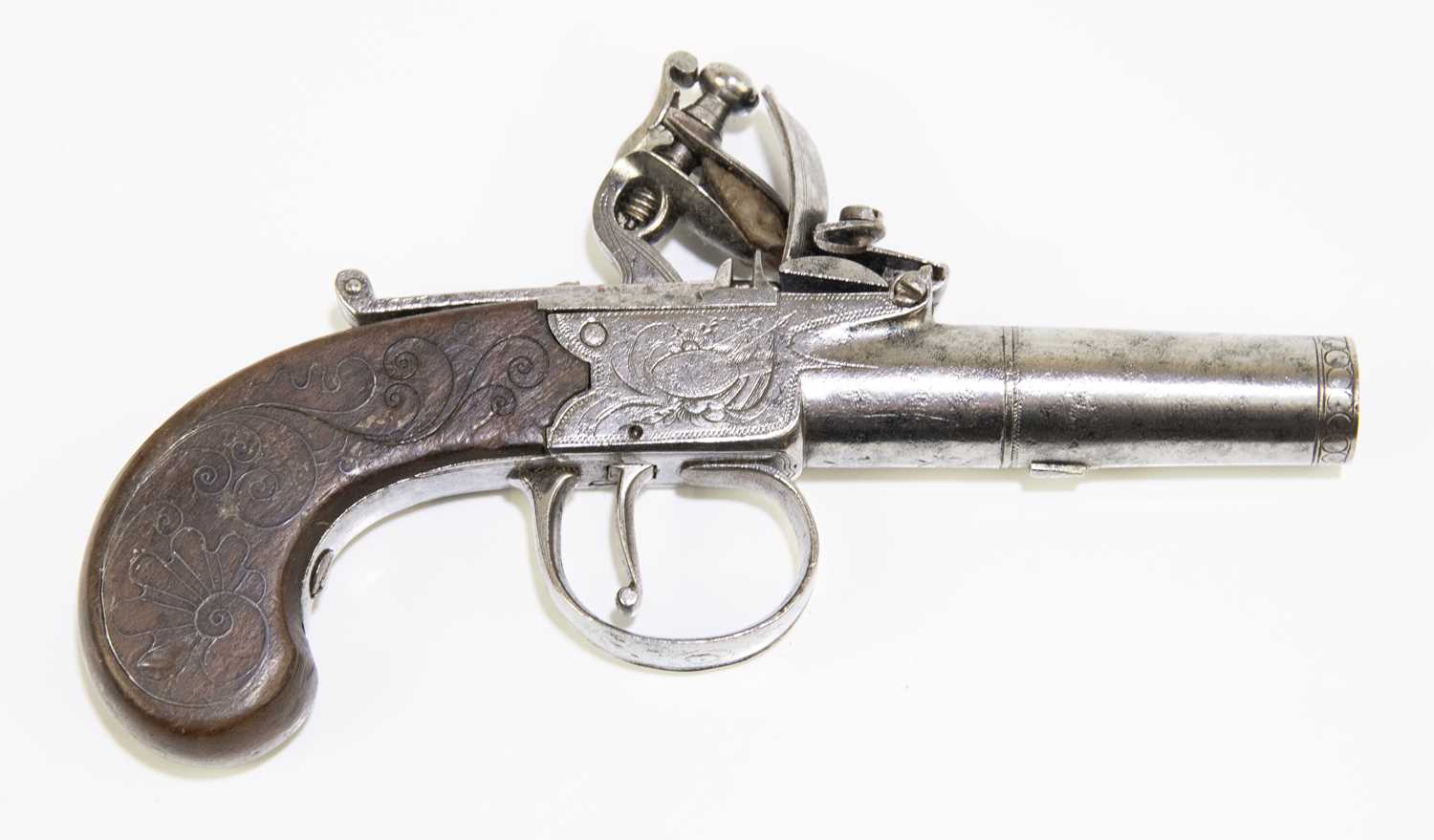 A late 18th/early 19th century flintlock muff pistol, the 1.5" screw-off barrel mounted to the