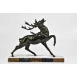 A large Art Deco bronzed spelter model of a stag with arrow through its back, on a marble plinth