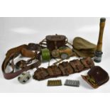 A group of military items including a cased pair of binoculars, ammunition, brown leather strap, gas