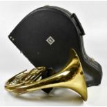 CLEVELAND; a brass plated French horn, cased.