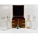 A 19th century brass bound oak campaign style decanter box, housing a set of four clear glass