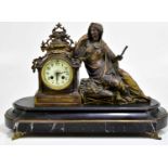 A Victorian mantel clock with bronzed metal mount, representing a seated female figure holding a