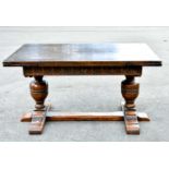 An oak draw-leaf refectory type dining table on baluster turned supports, width 138cm when not