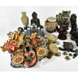A mixed group of various tourist pieces to include Indonesian masks, Buddhas, African sculptures,