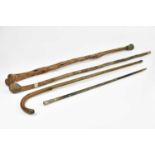 Two vintage walking canes, a similar walking stick and a swagger stick with ebonised shaft and