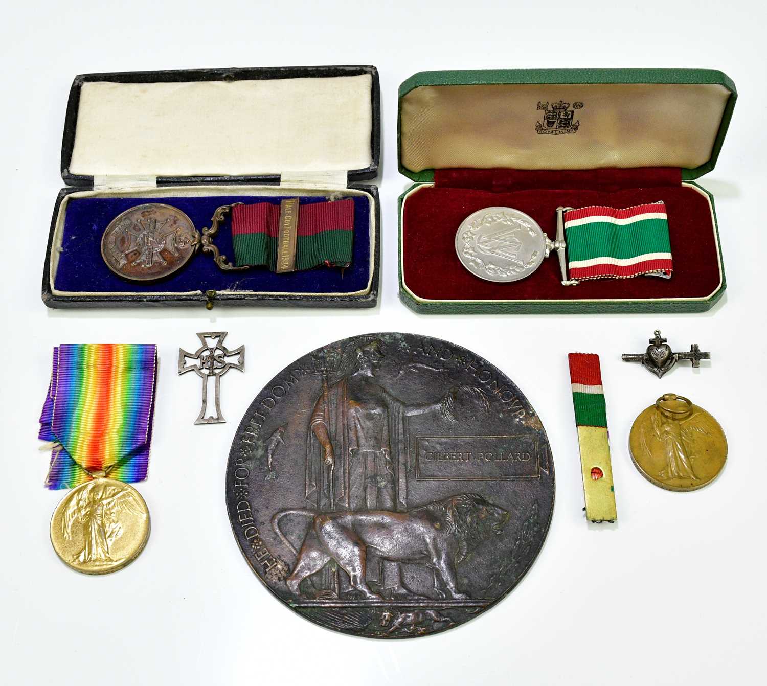A WWI bronze memorial plaque awarded to Gilbert Pollard, together a cased Women's Voluntary
