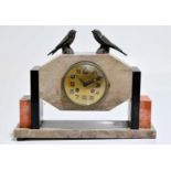 An Art Deco slate and marble mantel clock, mounted with bronzed metal birds above the brass dial set