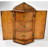 A 19th century oak hexagonal cabinet table top with two doors enclosing three drawers, height