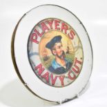 A 1930s wall mirror with later printed sticker, Player's Navy Cut cigarette, diameter 29cm.