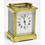A late 19th century French brass carriage clock, the enamel dial set with Roman numerals, height