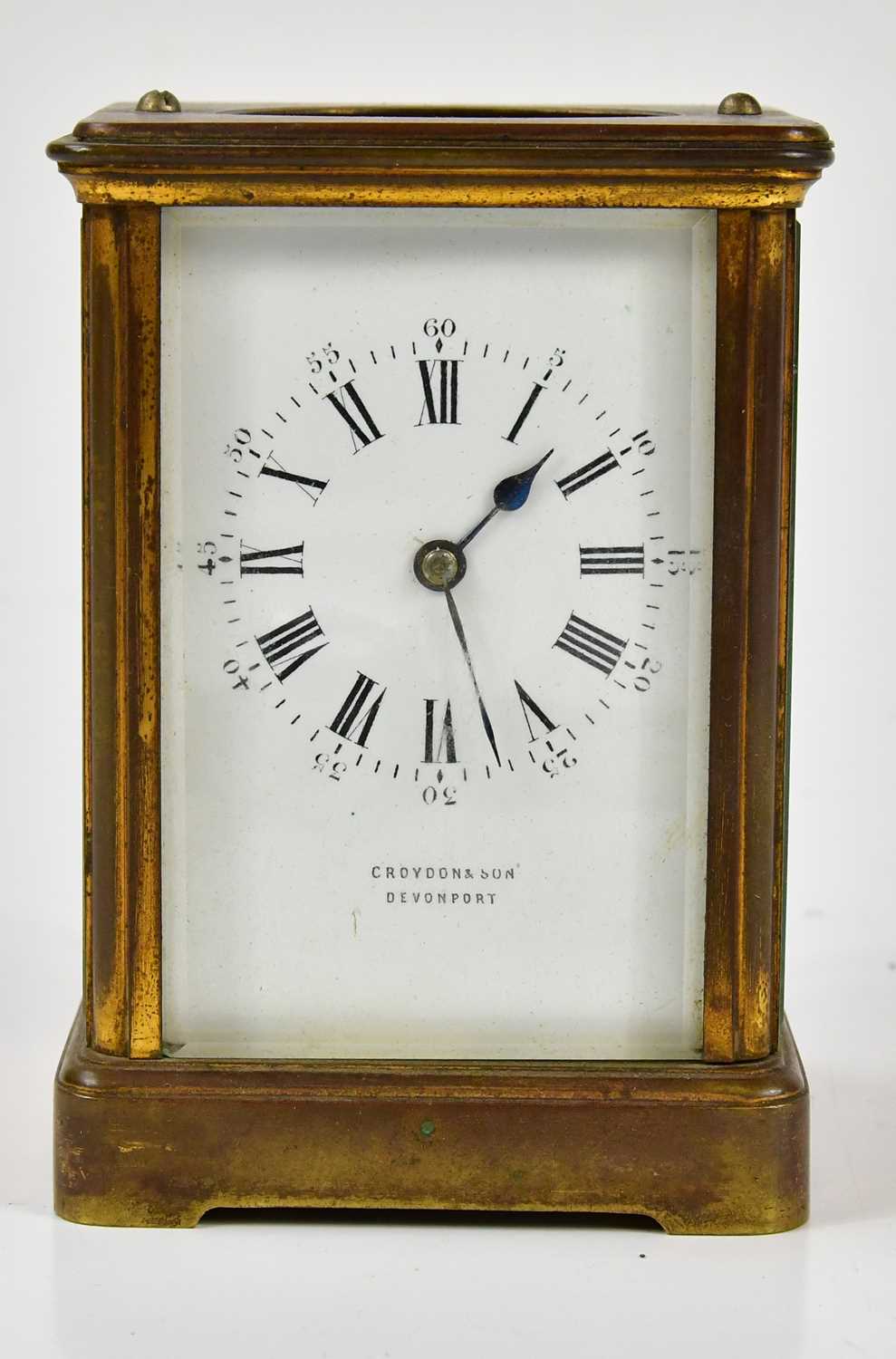 A late 19th century brass cased carriage clock, the enamel dial bearing Arabic and Roman numerals,