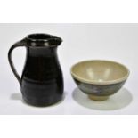 ST IVES POTTERY; a tenmoku glazed jug, height 15.5cm, with a St Ives Pottery footed bowl (2)