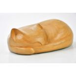 † TOM LAL (1927-2016); a carved wooden model of a sleeping cat, length 26cm.