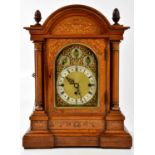 A 19th century inlaid rosewood bracket clock, with carved acorn finials, flanking the arch shaped