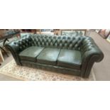A green leather three seater Chesterfield sofa, length 173cm.