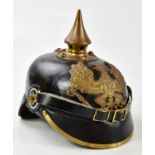 A reproduction pickelhaube with replaced leather inner and chin strap.