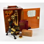 W. WATSON & SONS LONDON; a brass and lacquered microscope, together with an assortment of lenses, in