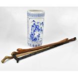 Two unusual walking canes with carved heads, two further walking sticks and a modern Oriental blue