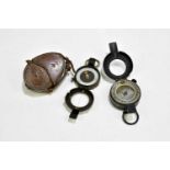 Two military compasses, one in leather case.