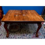 An early 20th century mahogany wind-out extending dining table, with three additional leaves,