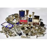 A large collection of electroplated items to include a rose bowl, vases, a teapot, cutlery, napkin