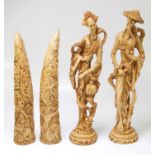 A pair of decorative resin tusks, height 41cm, and a pair of figures.