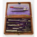 A cased set of drawing instruments to include pencils and protractors, etc.