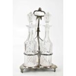 A 19th century silver plated bottle stand, housing three cut glass decanters, height 42cm.