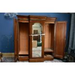 A Victorian mahogany breakfront wardrobe with central mirror door and fitted interior