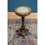 An early Victorian rosewood sewing table with circular needlework panel to the lift off top,